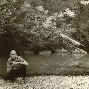 Albert Brumley posing by a creek in the early 1970's