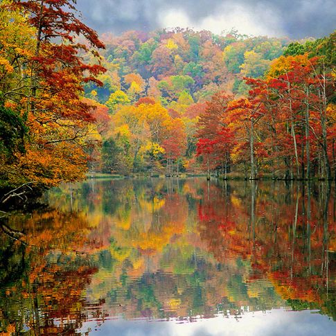 Beavers Bend State Park puts on a majestic show as its spicy fall colors reflect on the smooth-as-glass surface of the water.