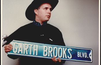 Garth Brooks holds the autographed Yukon street sign named his honor.