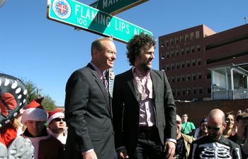 Oklahoma City Mayor Mick Cornett and Wayne Coyne of The Flaming Lips stand beside the Flaming Lips Alley sign.