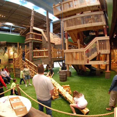 A two-story treehouse welcomes guests to the Gadget Trees exhibit at Science Museum Oklahoma.  Visitors can slide down one of the nation's tallest spiral slide and learn about simple machines, like a lever cleverly disguised as a teeter-totter.