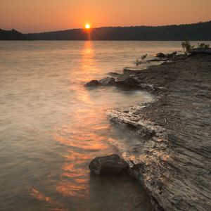 Hike along the rocky shores of Lake Wister to find the ultimate sunset-viewing spot. Photo by Kim Baker/Oklahoma Tourism.