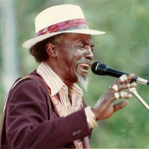 D.C. Minner performs at his home in Rentiesville.